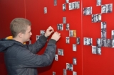 Anatoli Slavov adds portraits on the photo wall at Lijssenthoek 